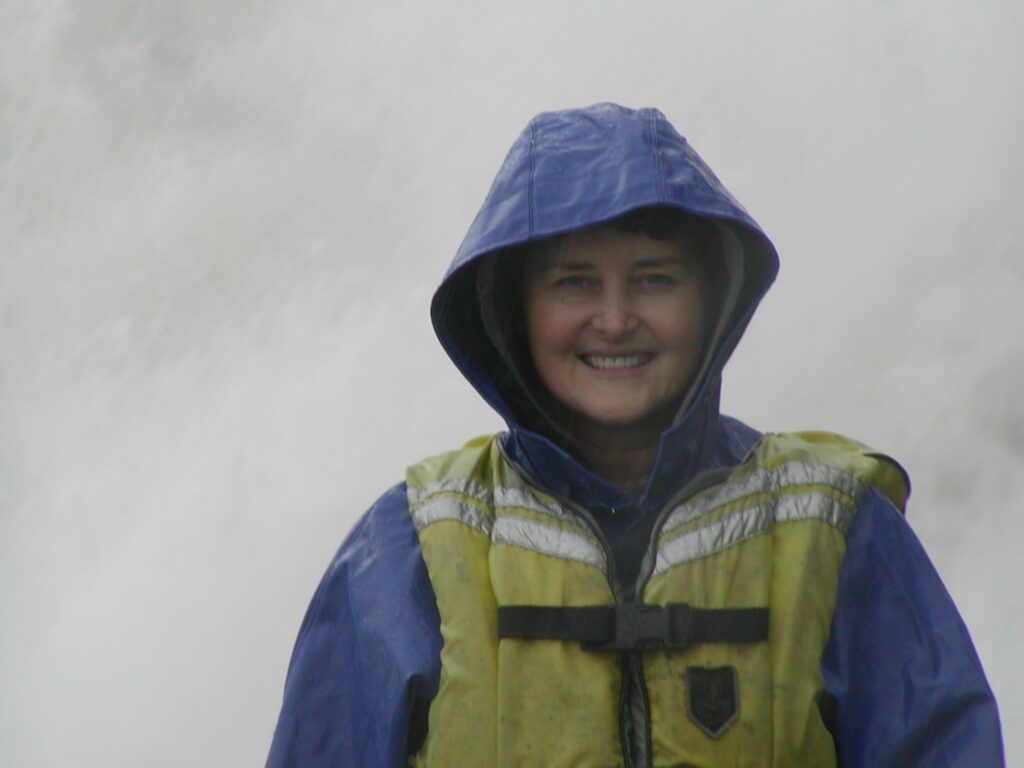 Marie Goff is standing next to Mendenthall glacier in Alaska