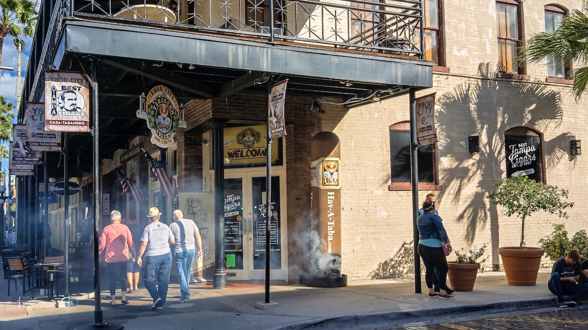 7th Avenue in ybor City is the Tabanero Cigars Store and people are strolling by on the street