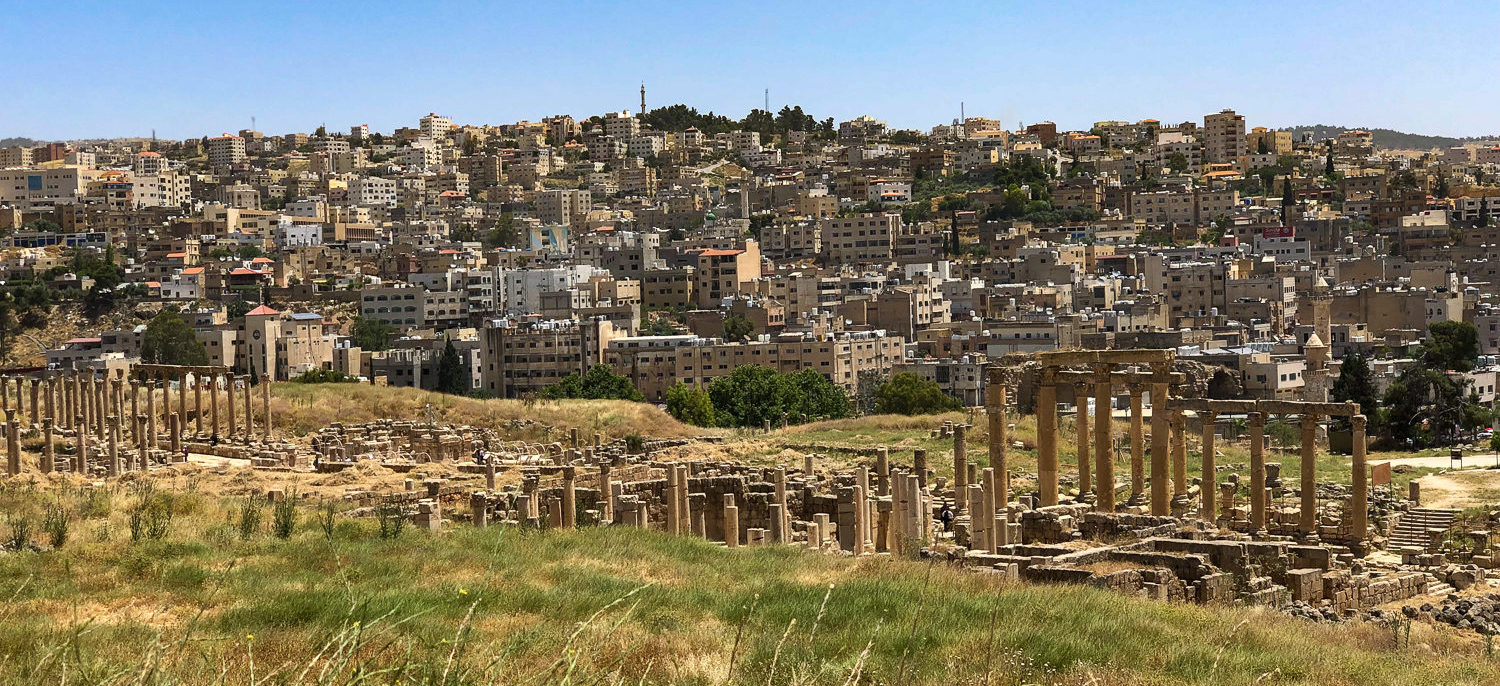 On our expedition to Jordan, we saw many ancient ruins at the edge or in the middle of modern cities. This is a picture of Amman with rluins in front of it.