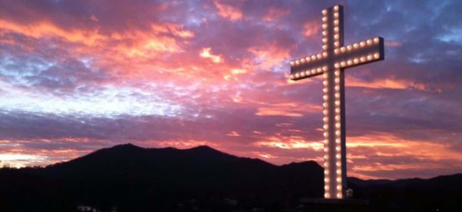 A hidden gem near Maggie Valley. The cross at Lake Junaluska against a red sky.