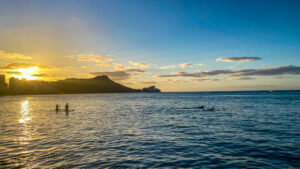 Surfers at sunrise over Diamond Head