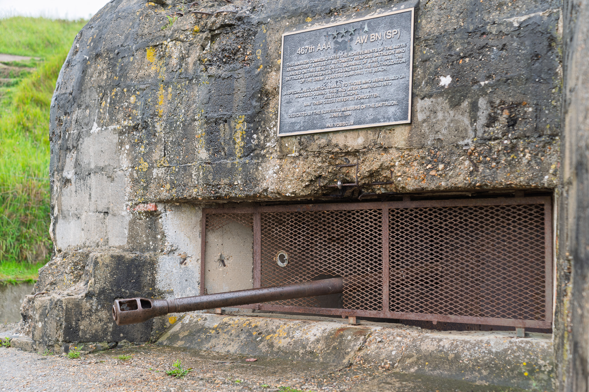 German Bunker WN65 with inscription honoring The 475th Anti-Aircraft Artillery Automatic Weapons Battalion on the anniversary of D-Day.