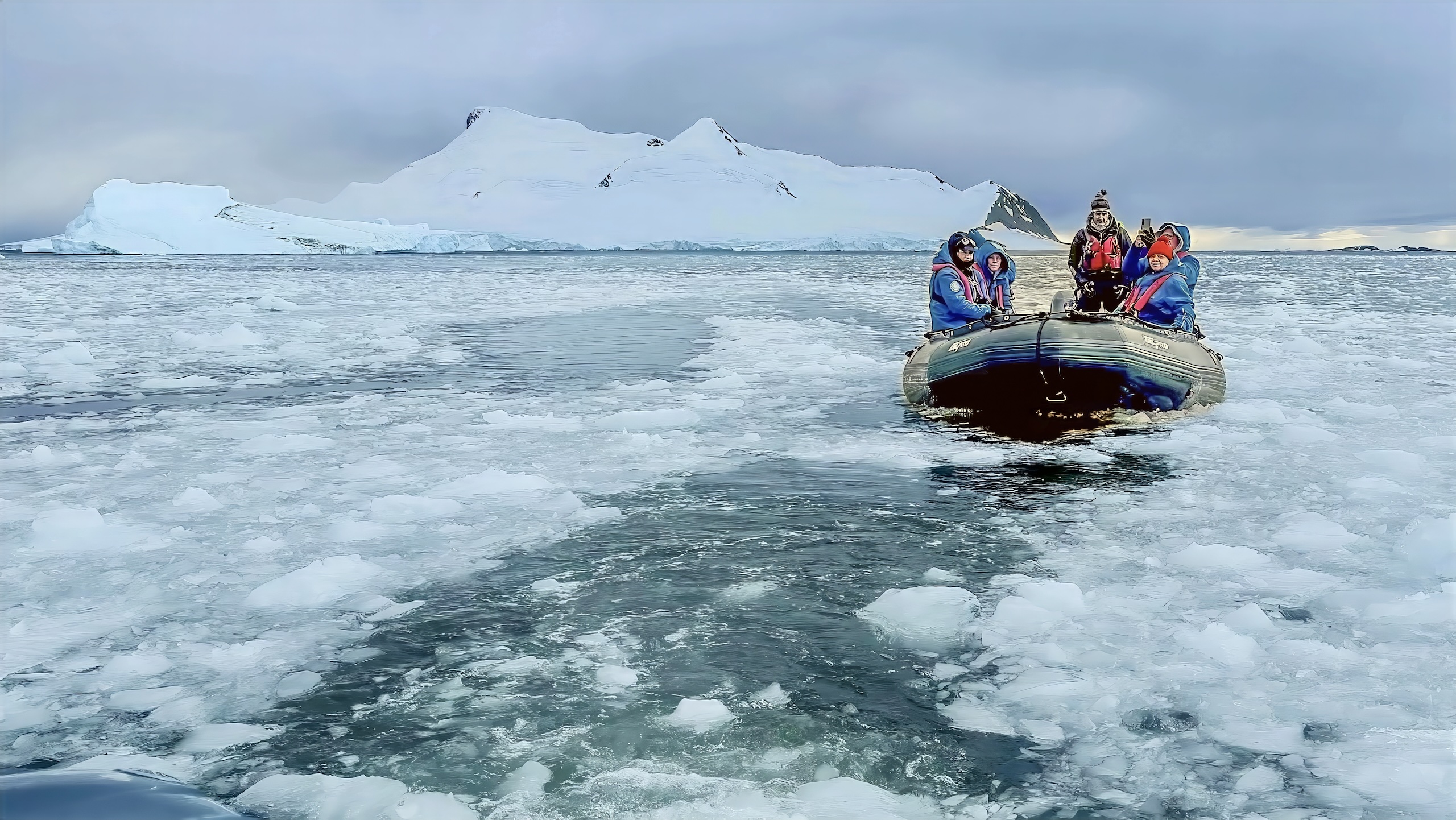 Zodiac is traveling with explorers in brash ice waters of Antarctica.