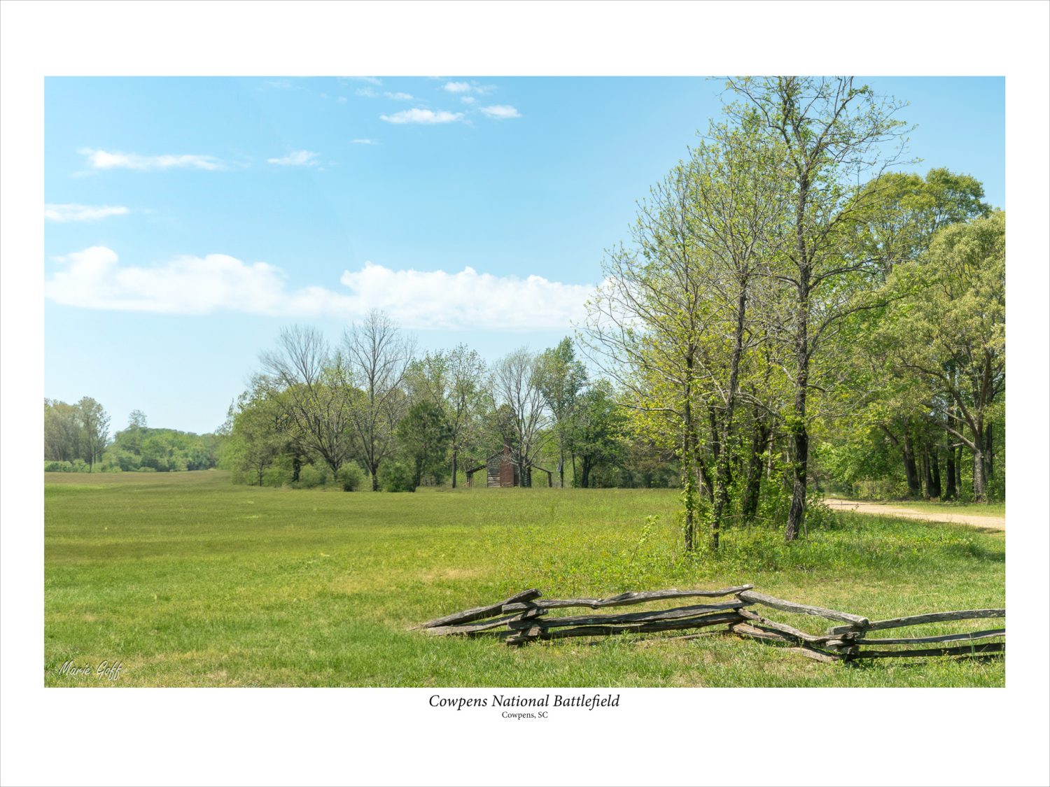 Cowpens National Battlefield with period log cabin in the distance.