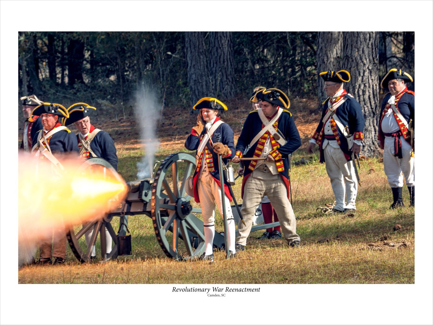 South Carolina’s Revolutionary Reenactment. A five -person team with one person igniting the cannon. The fire explodes from the cannon; this is called the muzzle blast.