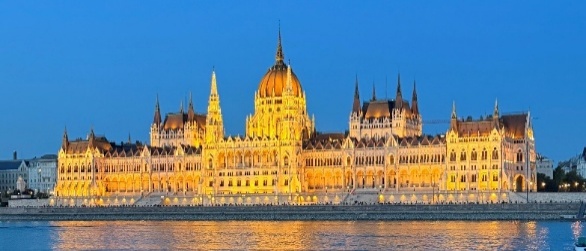 Hungarian Parliament Building in Budapest with a 'Blue Hour' sky and the Danube River in front.